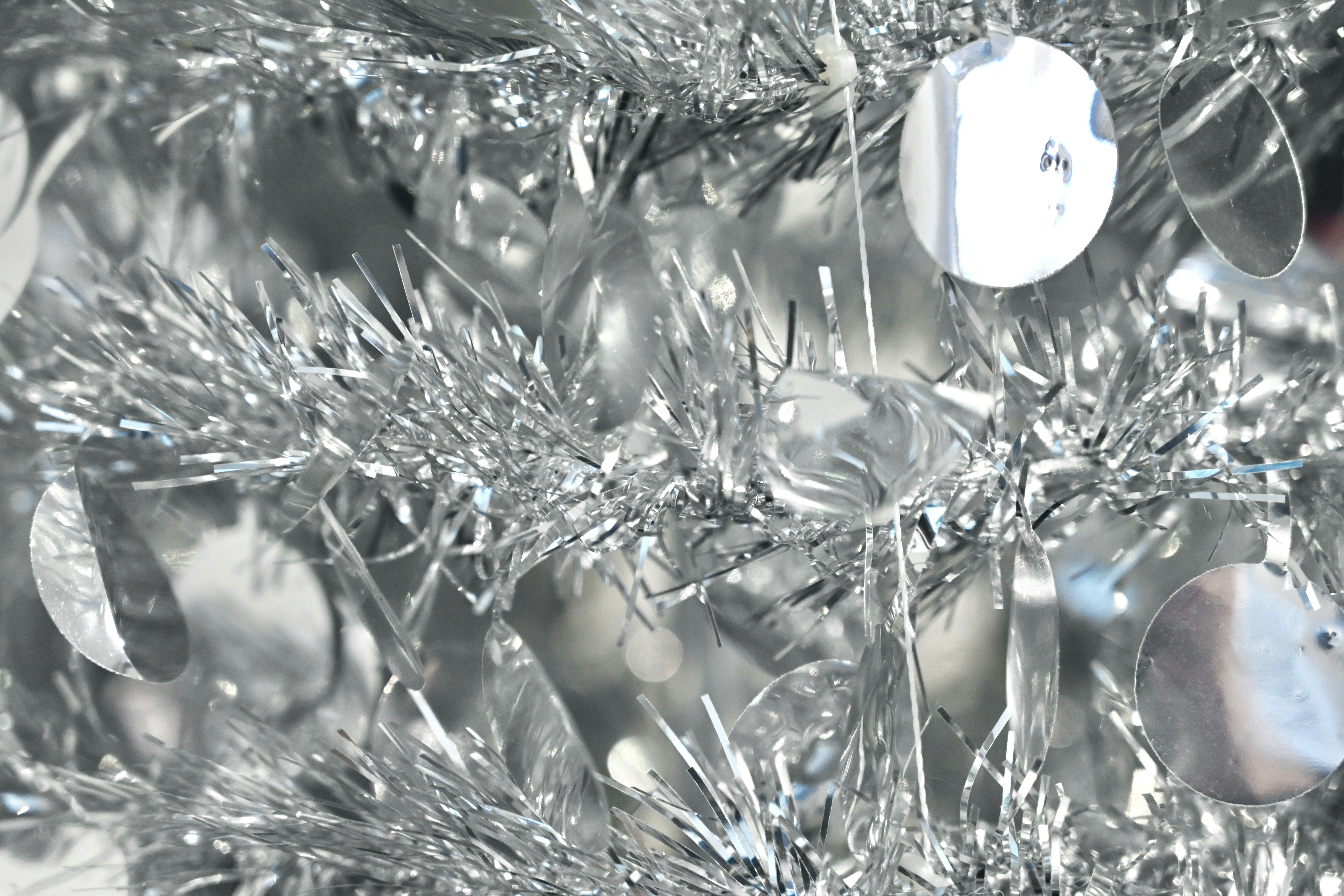 white and blue christmas baubles on green plant