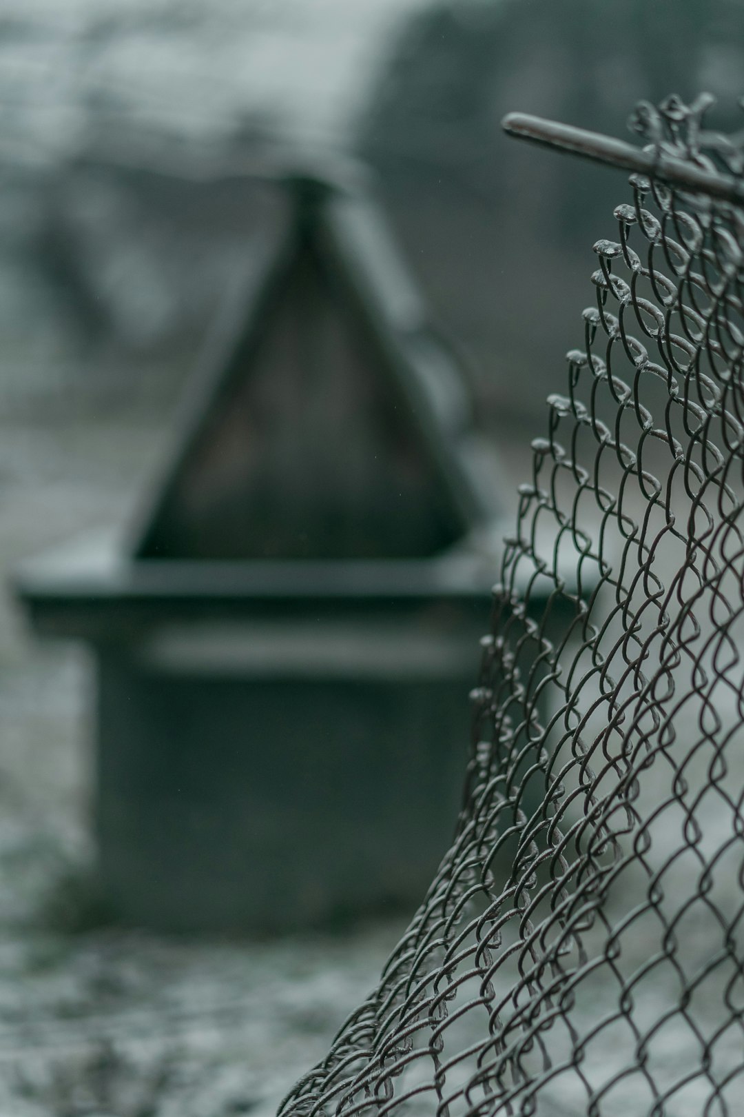 grayscale photo of a chain link fence