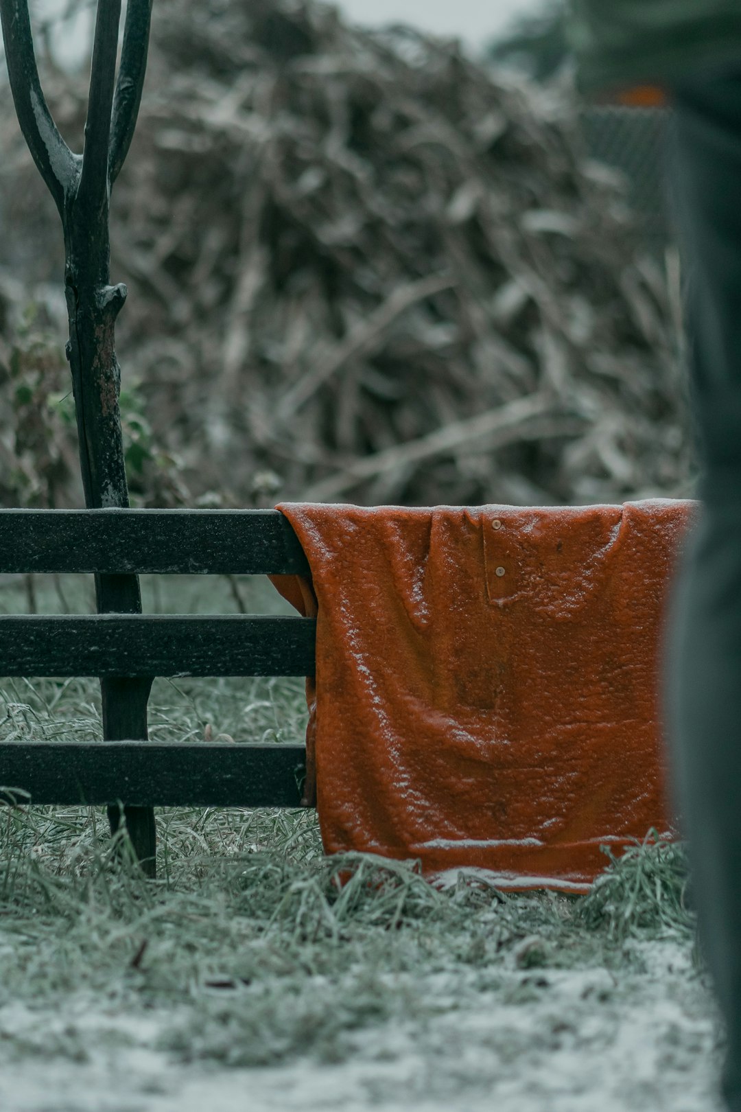 orange textile on brown wooden bench