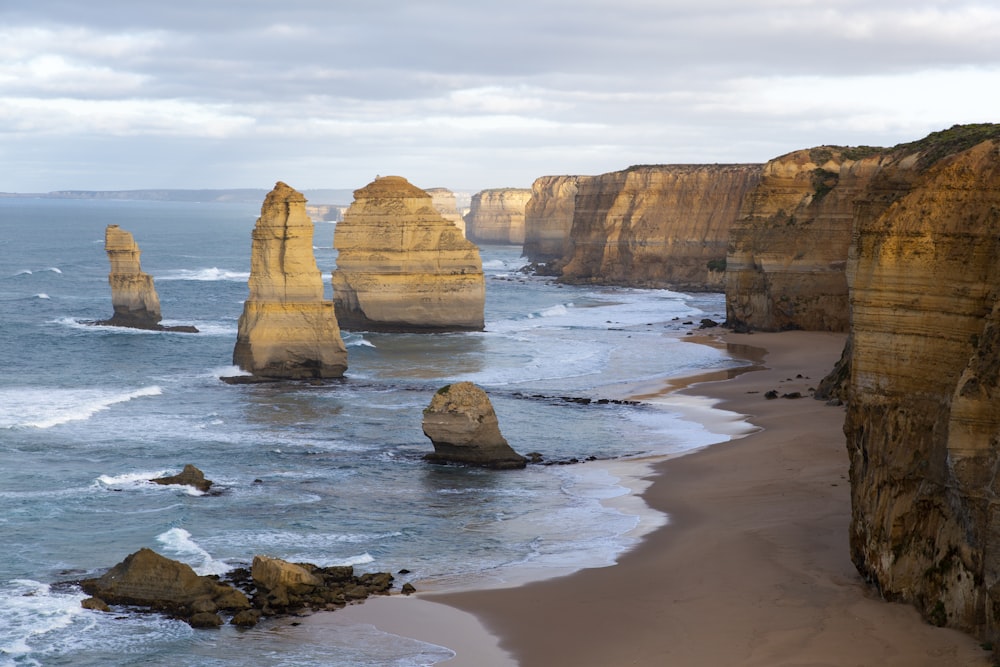 brown rock formation on sea shore during daytime