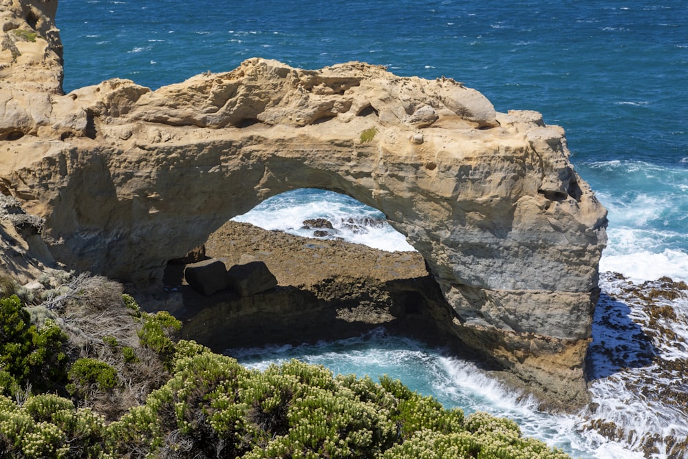 brown rock formation near blue sea during daytime