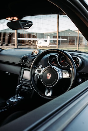 black car steering wheel during daytime
