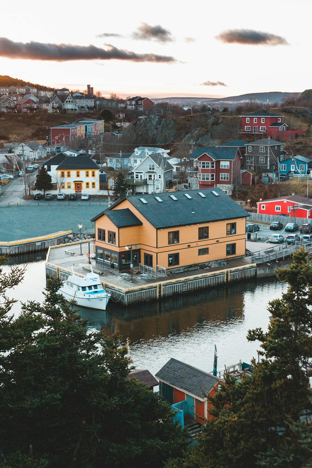 brown and white concrete houses beside river during daytime