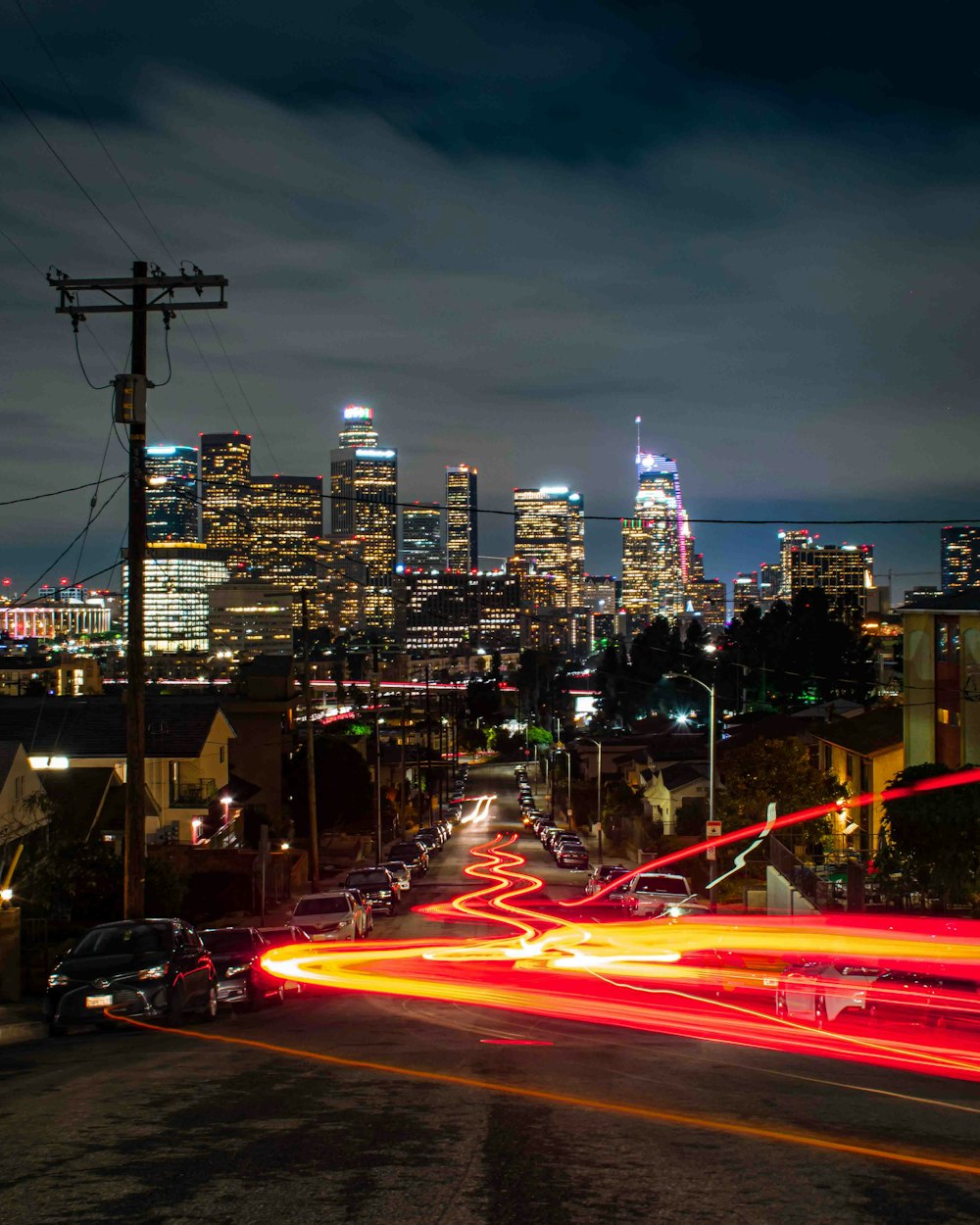 cars on road near city buildings during night time