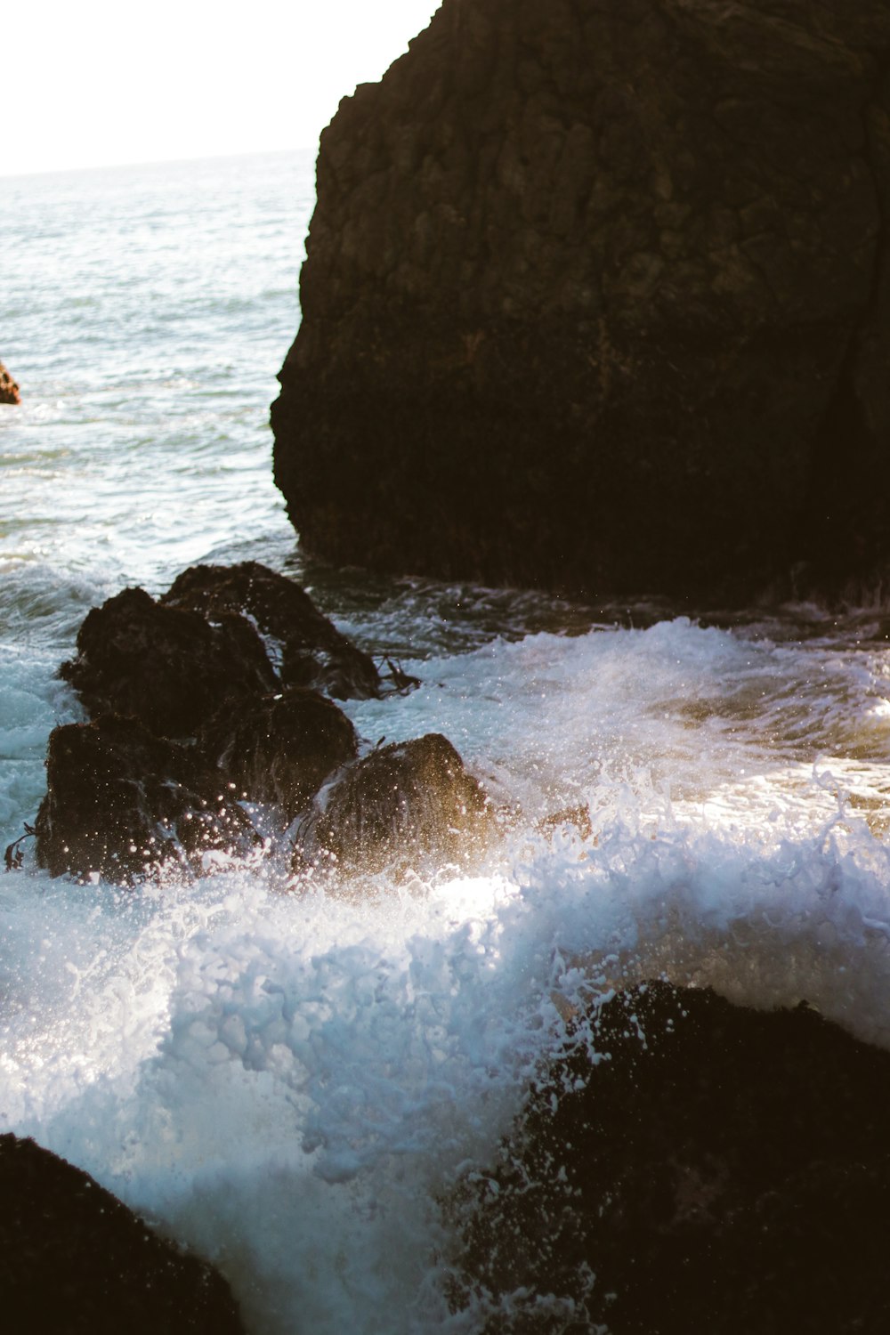 a man riding a surfboard on top of a wave in the ocean