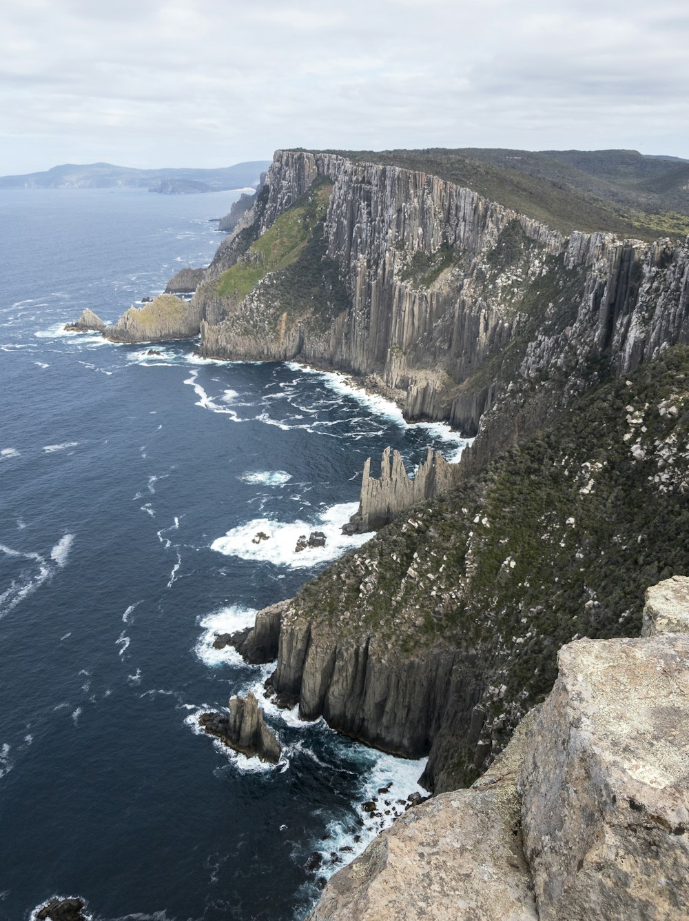 aerial view of green and brown mountain beside body of water during daytime