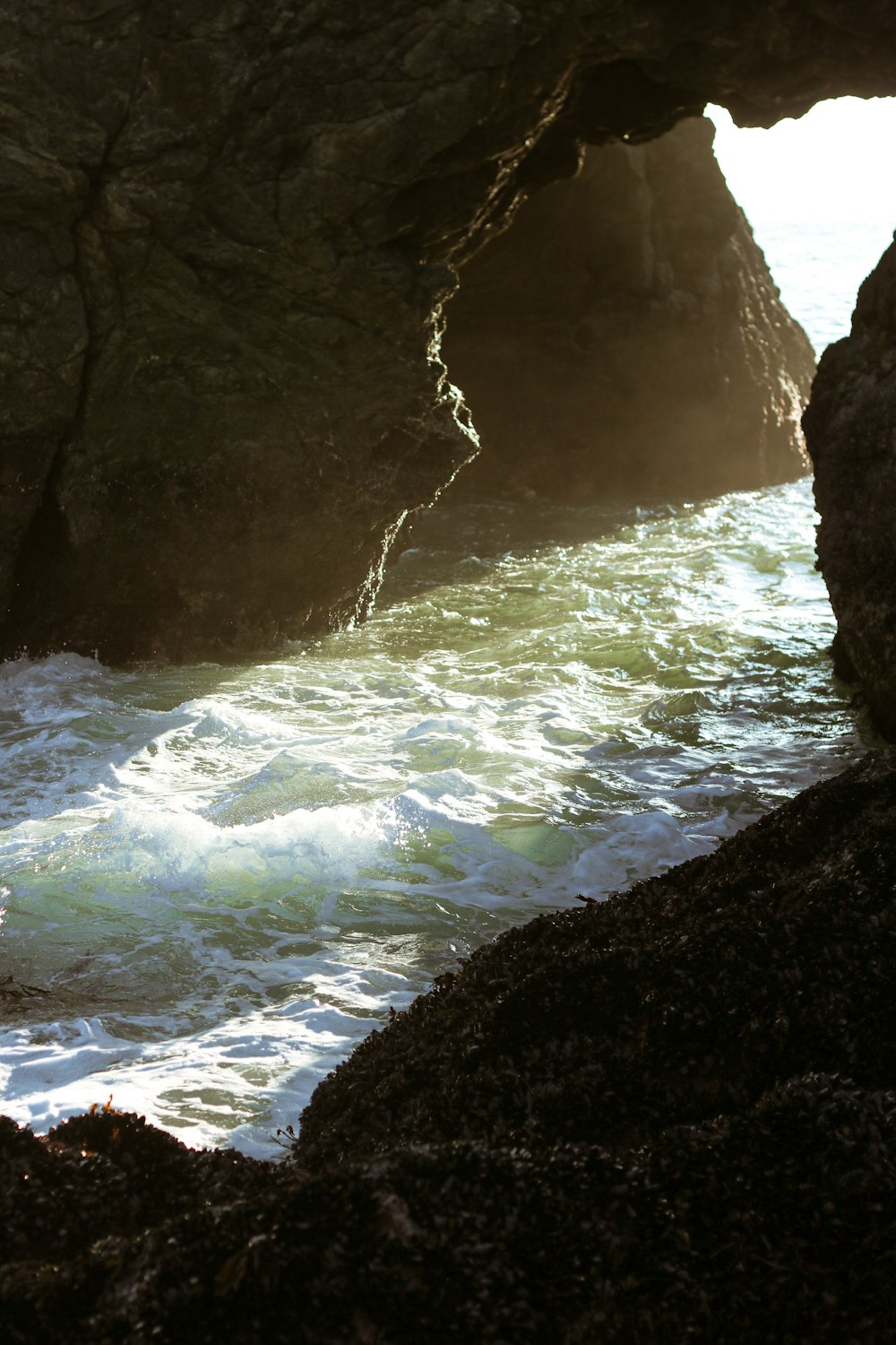 water falls in cave during daytime