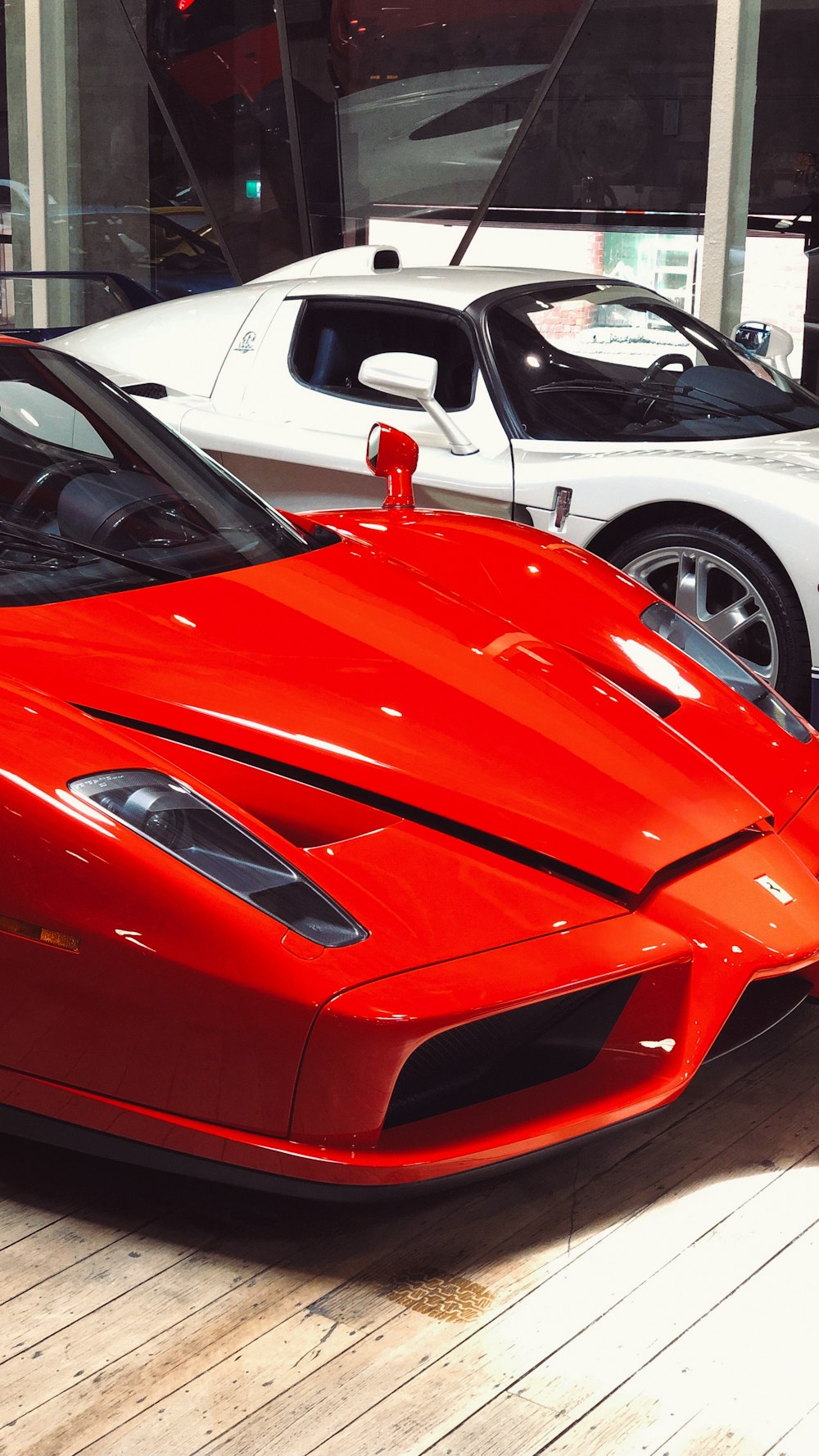 red ferrari car in a parking lot