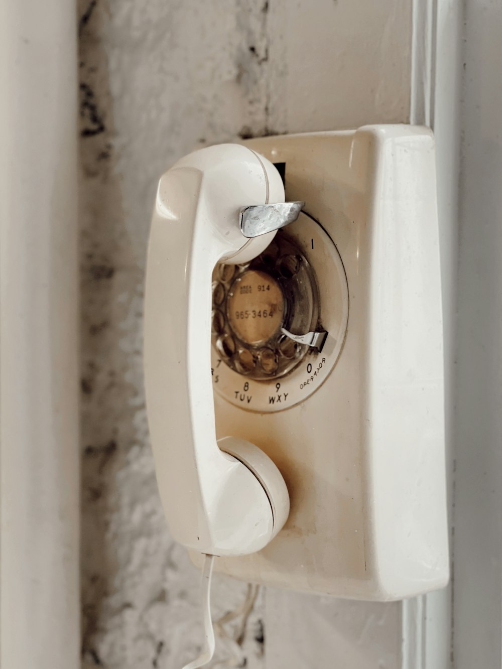 white rotary phone on white table