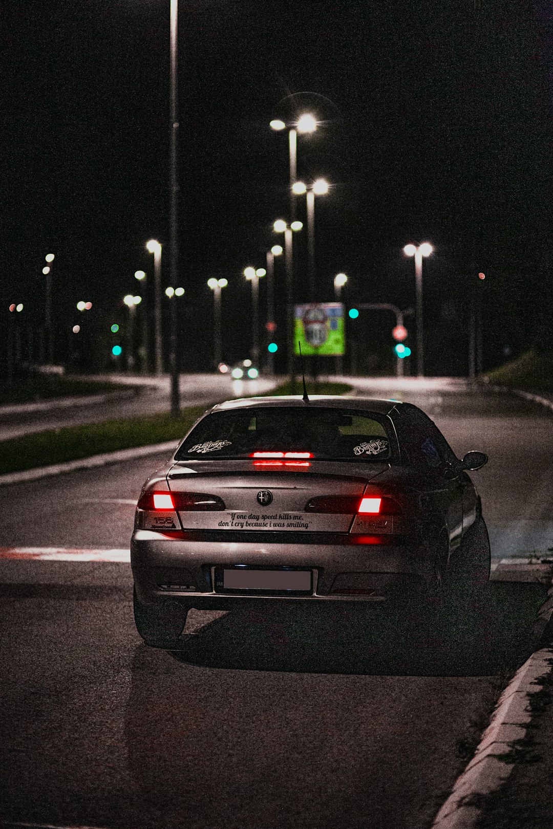 black car on road during night time