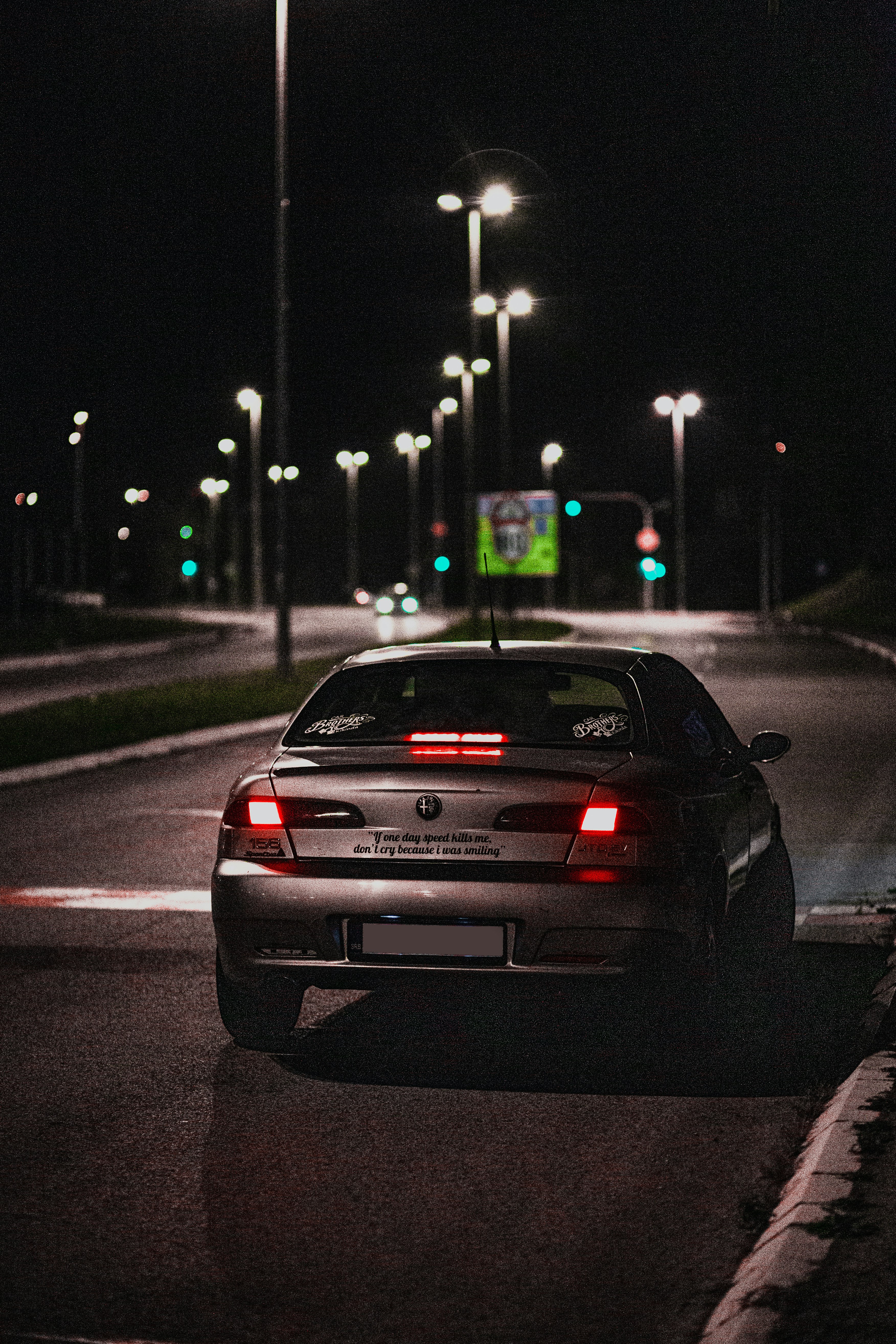 black car on road during night time