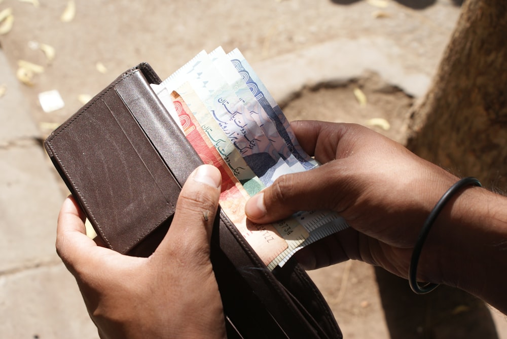 person holding white and blue card