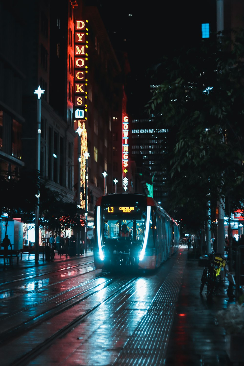 white and black tram on road during night time