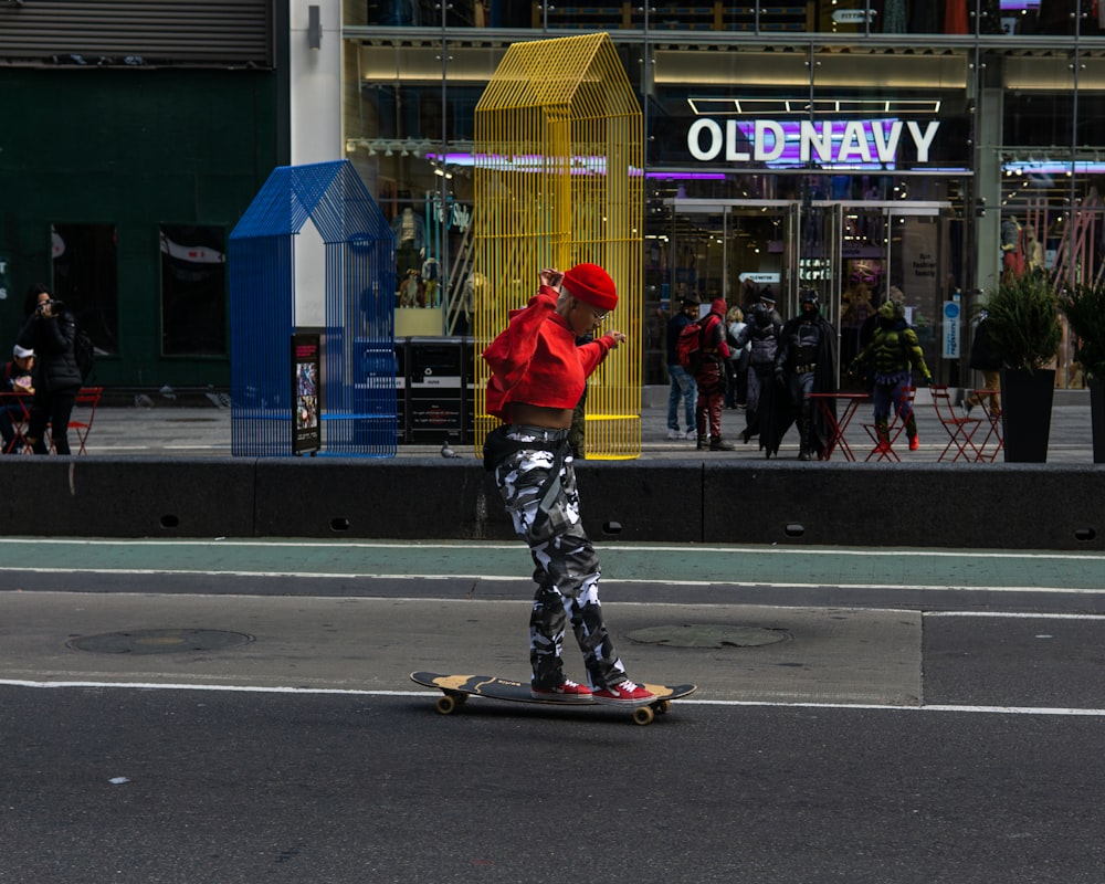 man in red jacket and black pants riding red skateboard