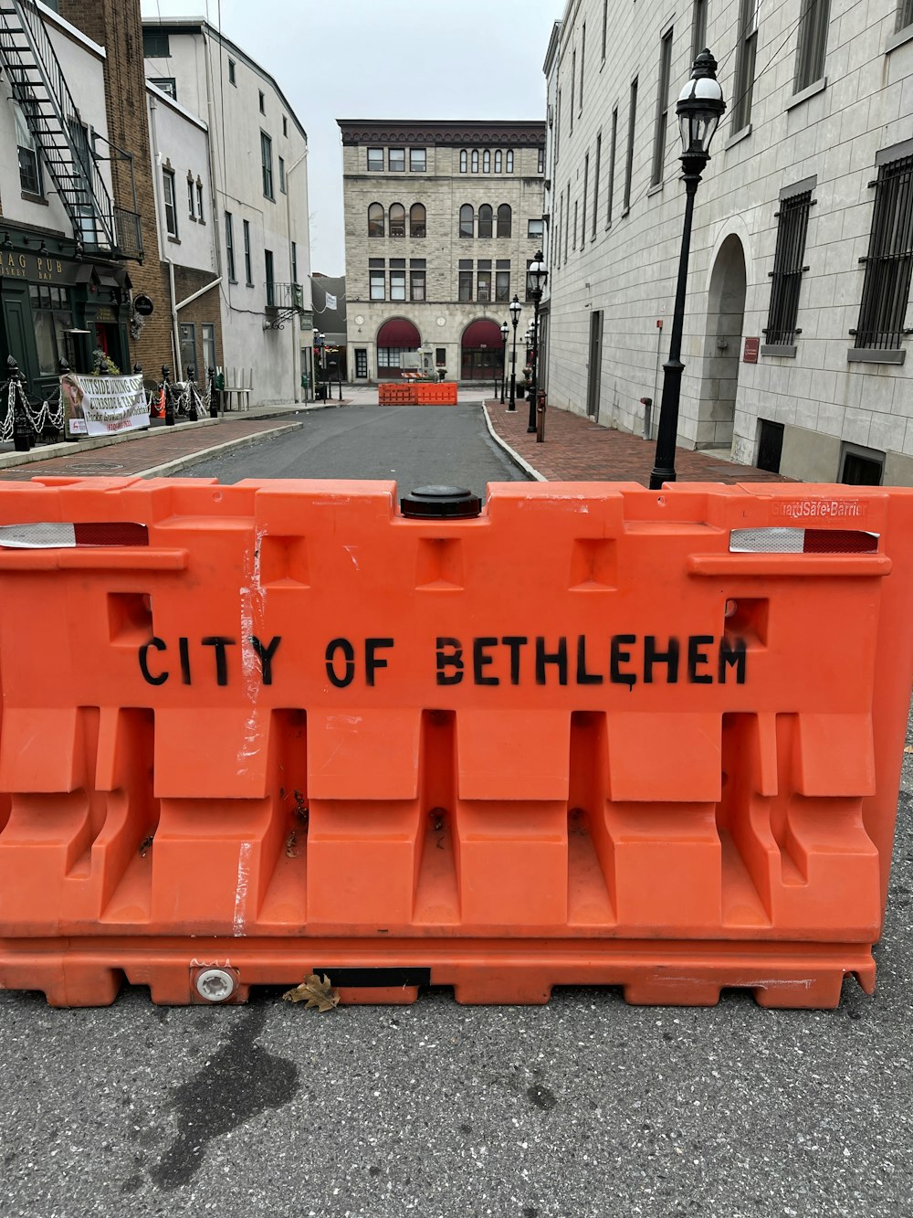 red plastic crate on road during daytime