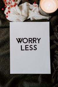 A sign with the words 'Worry Less' written on it, encouraging stress reduction and positive mindset.