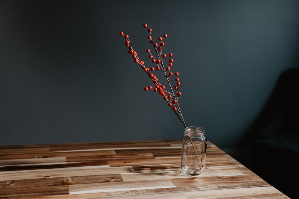 red and white flower in clear glass vase