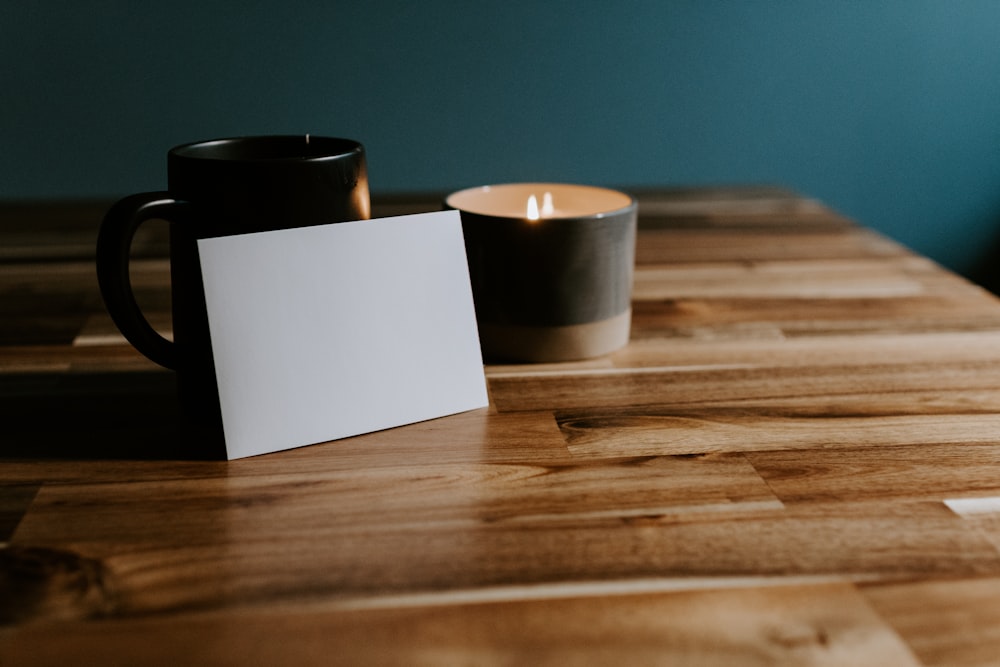 3 black and white ceramic mugs on brown wooden table