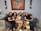 A group of women sharing joyful moments in a cozy setting.