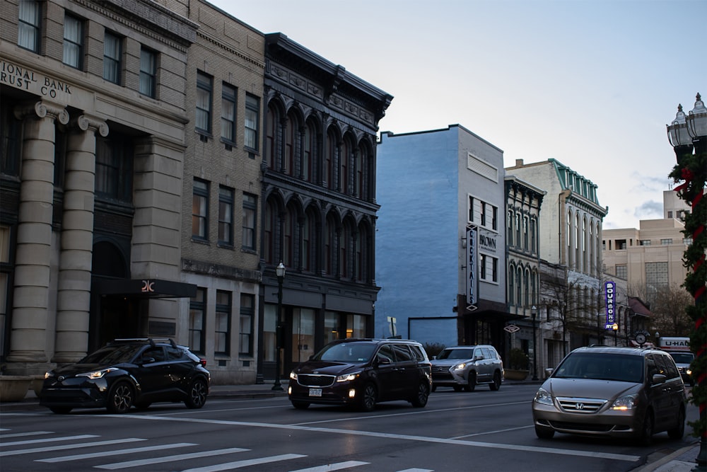 cars parked on side of the road near building during daytime