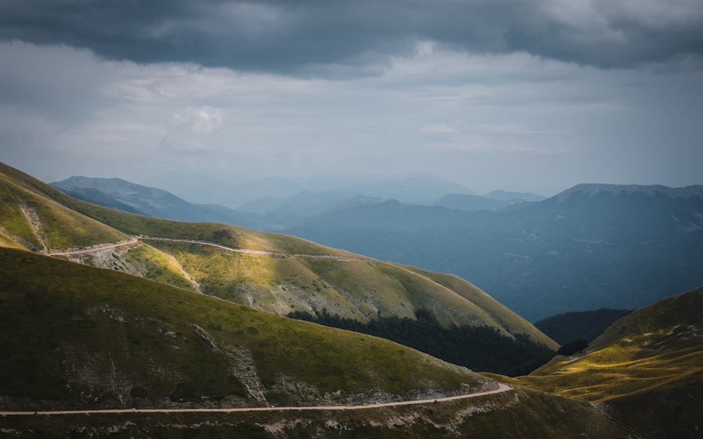 green and brown mountains under white clouds during daytime