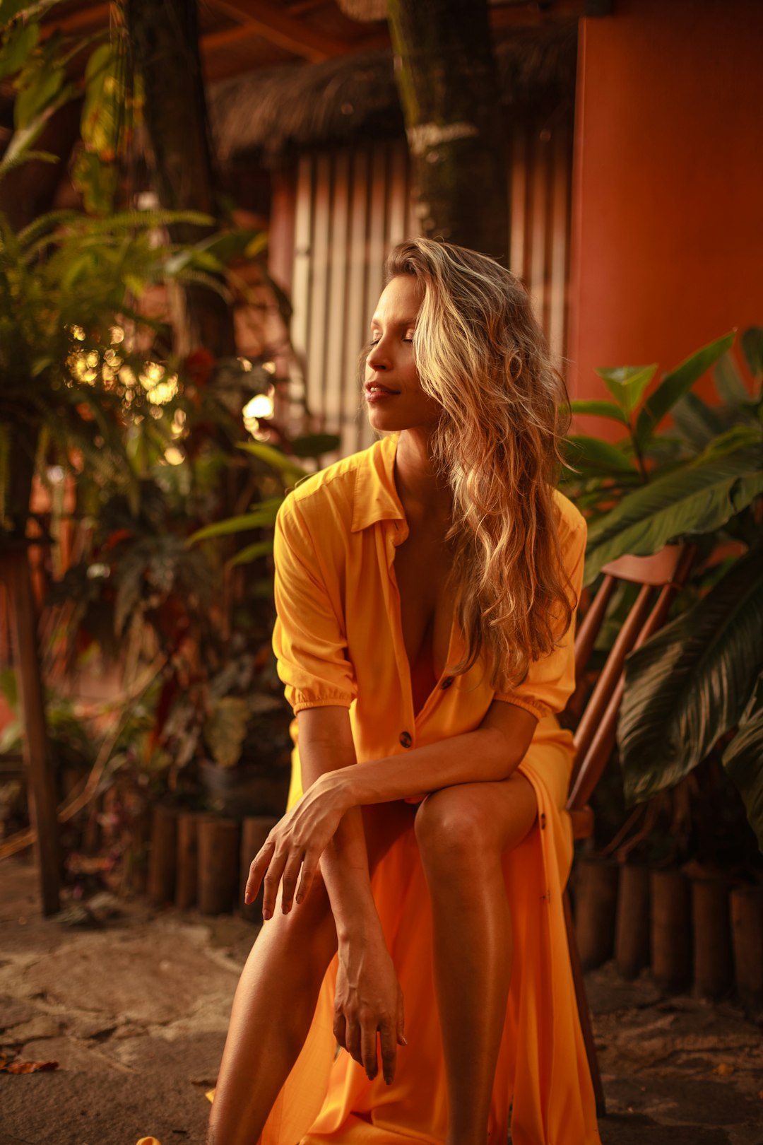 woman in brown long sleeve shirt sitting on brown wooden bench