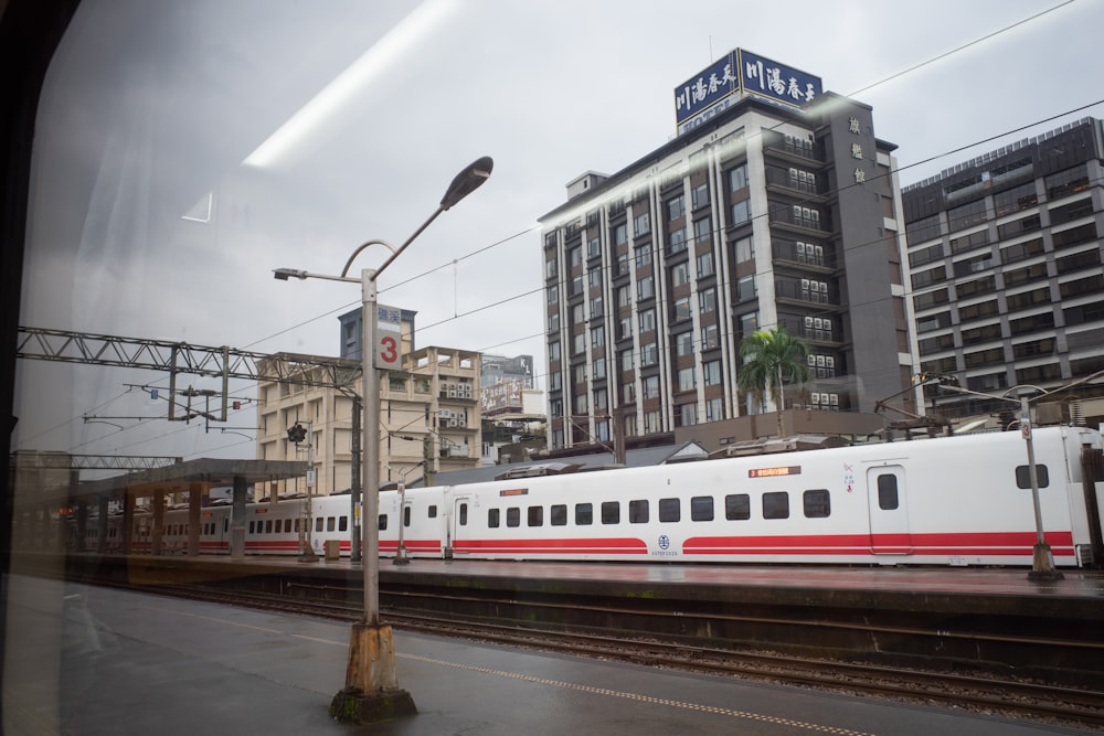 white red and blue train on rail road during daytime