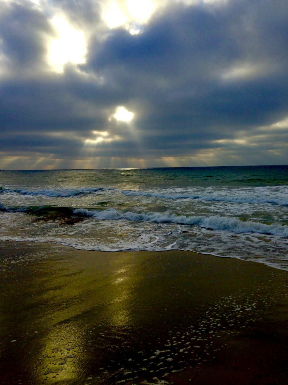 ocean waves crashing on shore during sunset