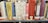 A row of books on a library shelf, featuring various titles related to Shakespeare and other literary topics. The books are in a mix of colors, and there are labels on the spines indicating their library classification.