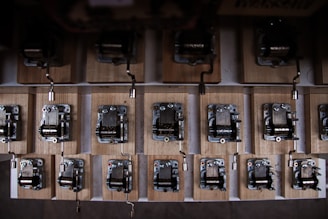 A variety of music boxes displayed on a rustic wooden table, showcasing different styles and finishes.