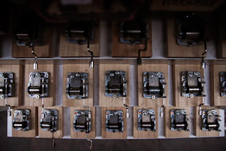 Close-up of an elegant wooden music box with intricate carvings and a gleaming brass winding key.
