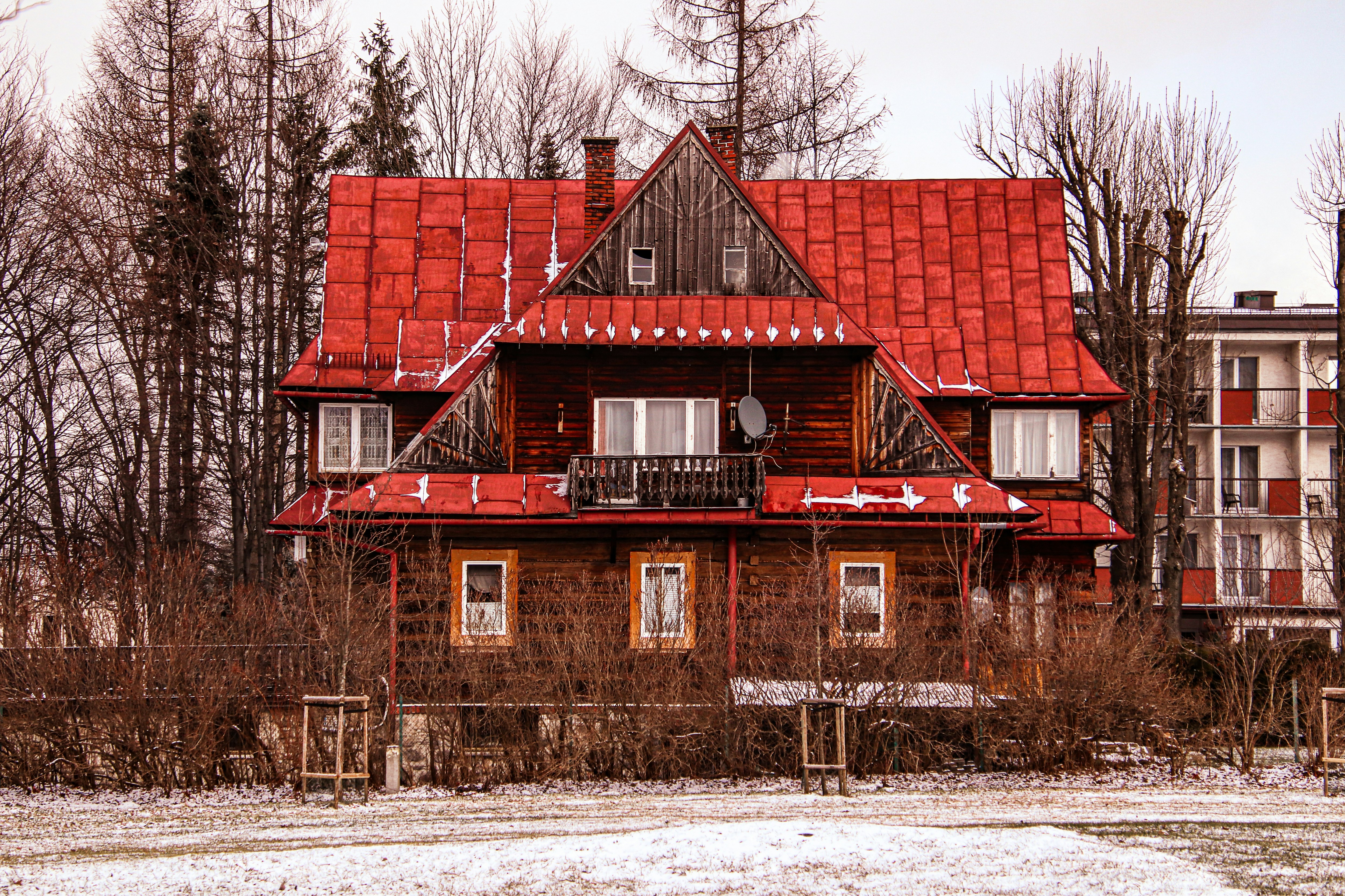 brown and black concrete house surrounded by trees during daytime