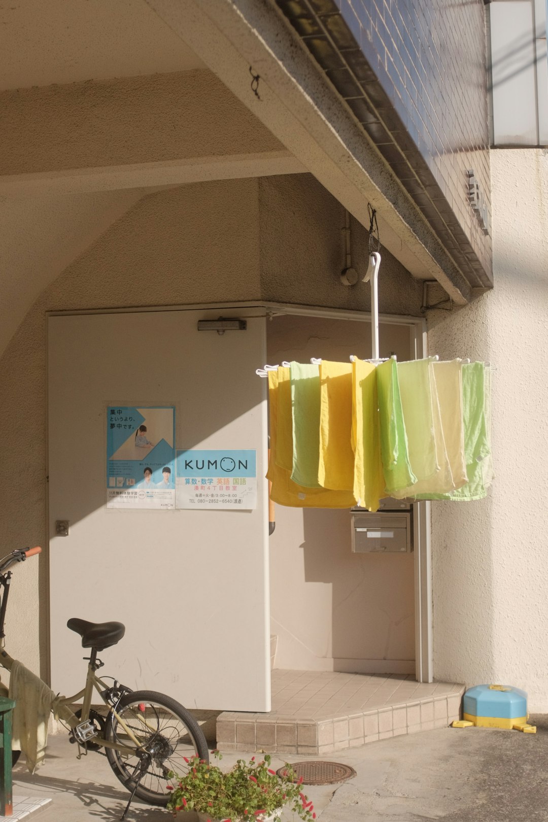 green and yellow plastic bags hanging on white metal pipe
