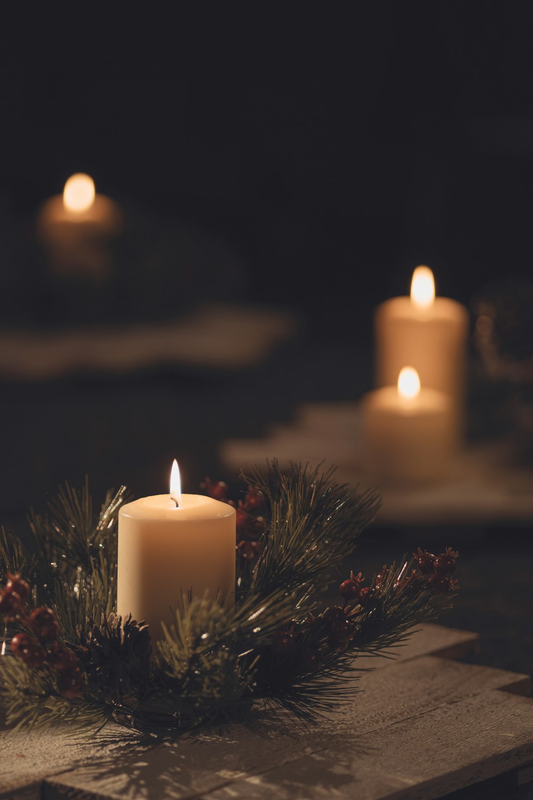 white pillar candle on brown wooden table