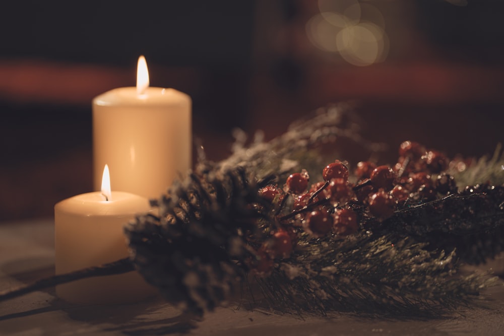 white pillar candle on brown wooden table