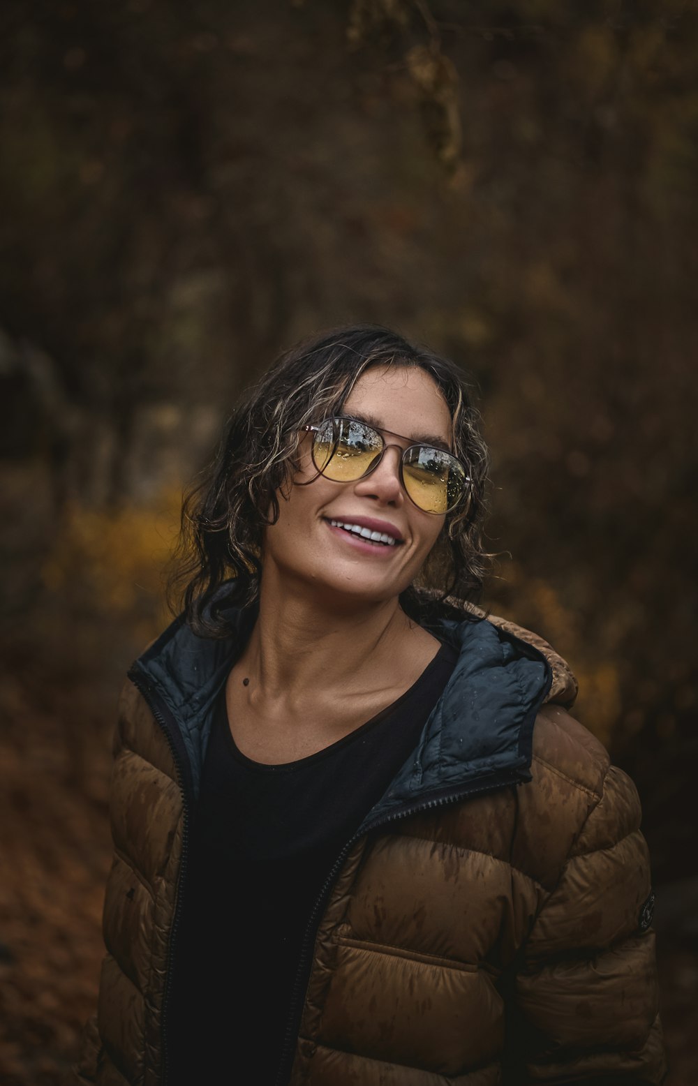 woman in brown jacket wearing black framed eyeglasses