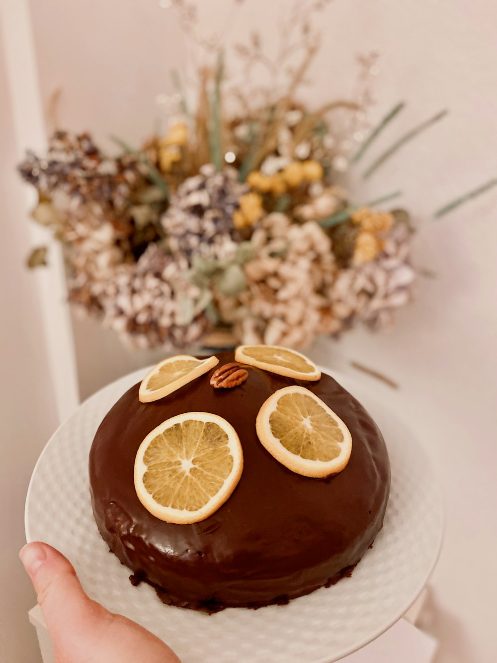 person holding sliced orange fruit