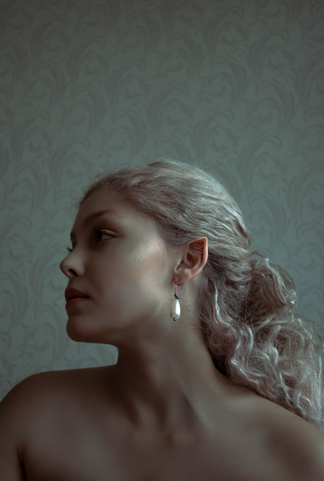 woman with white hair wearing silver earrings