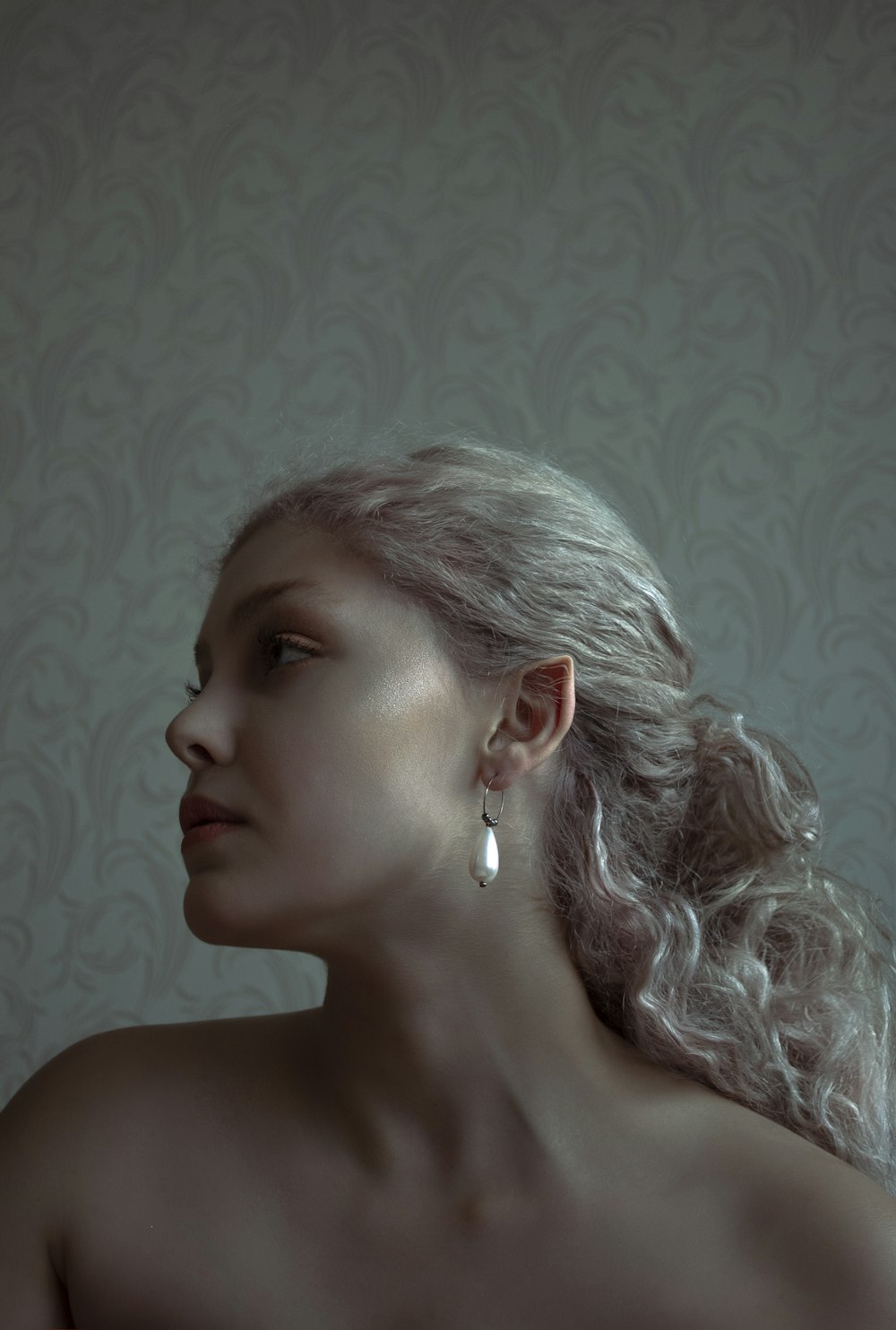 woman with white hair wearing silver earrings