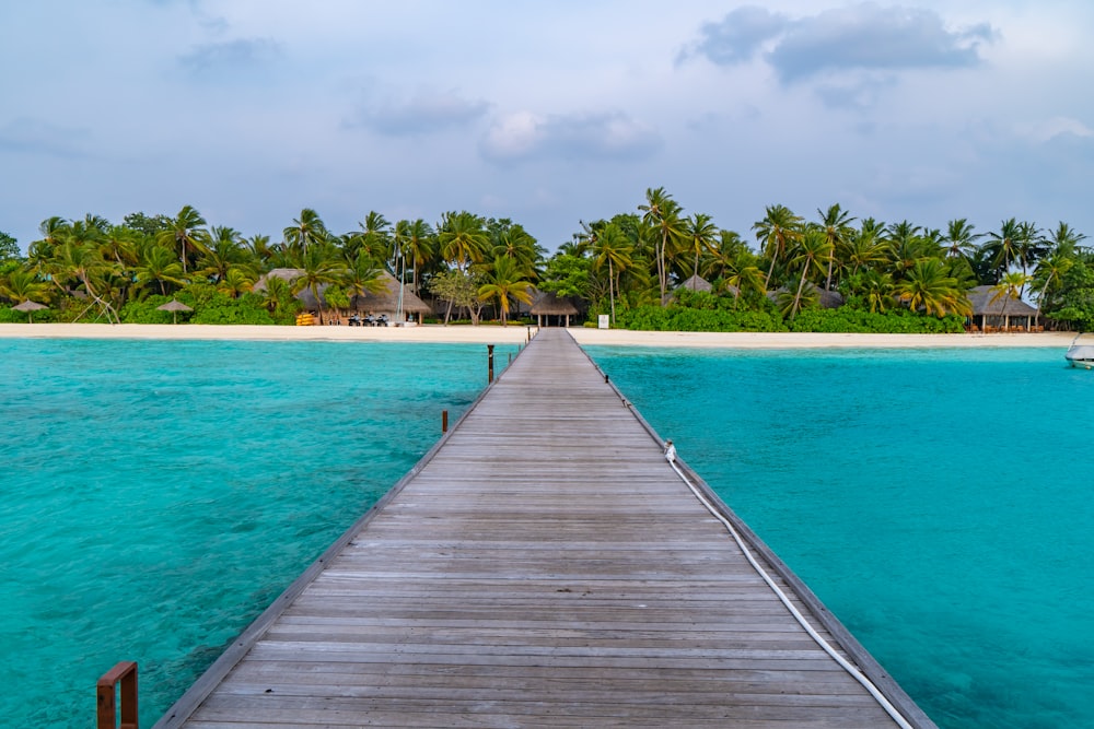 brown wooden dock on blue sea under blue sky during daytime