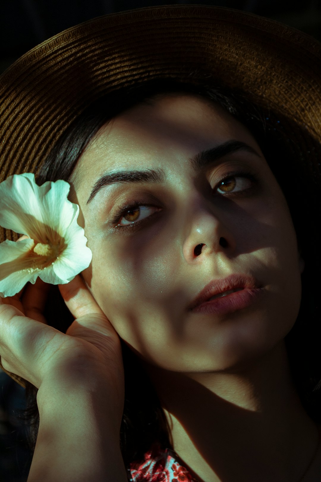 woman holding yellow and white flower