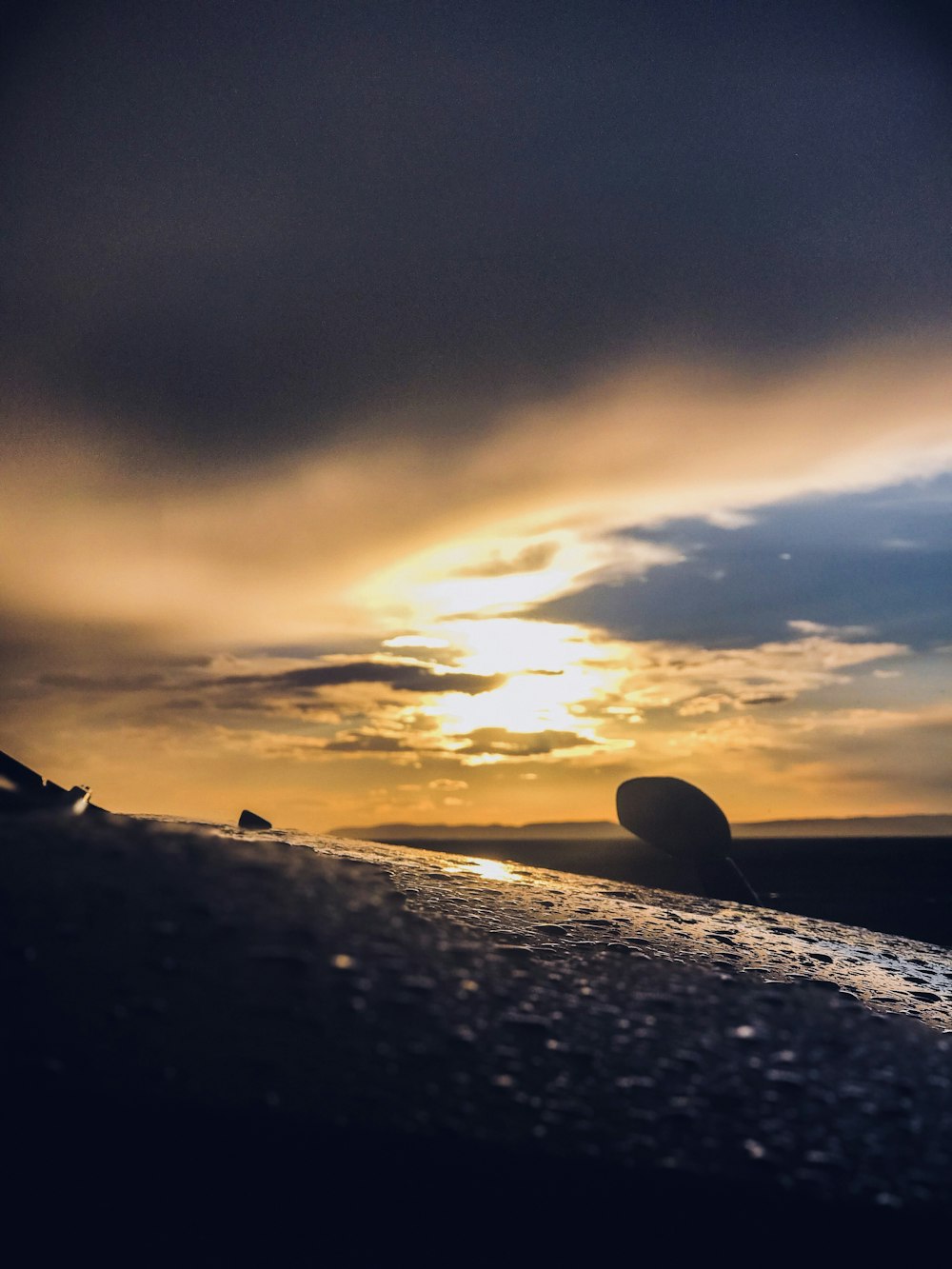 silhouette of rocks on beach during sunset