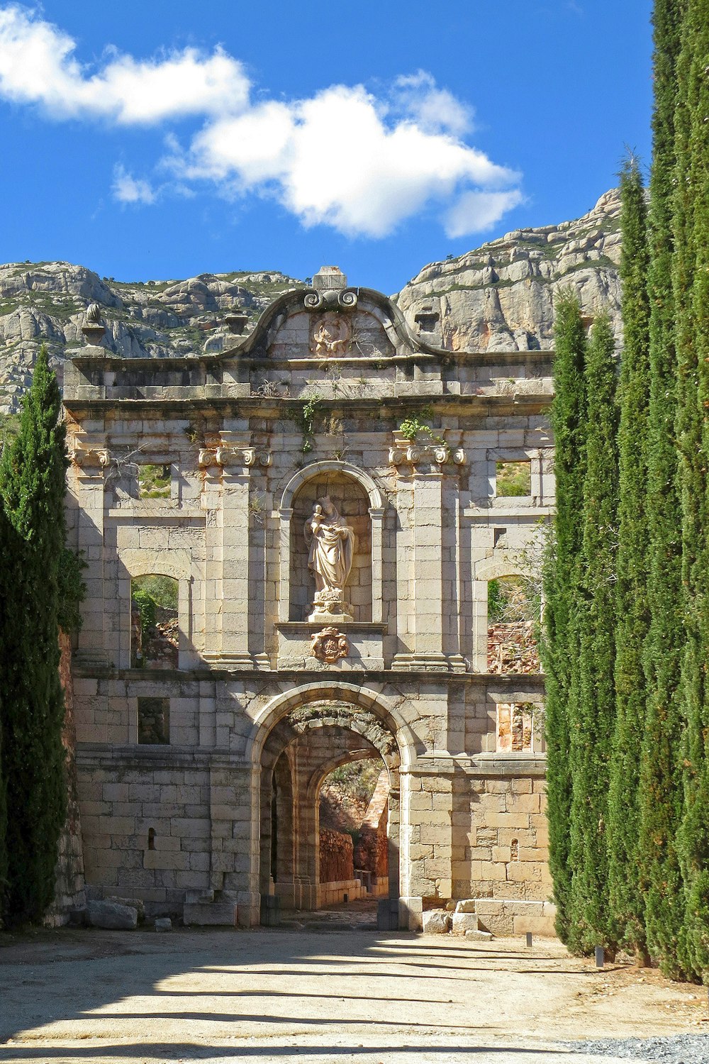 brown concrete building with green moss on top