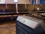 A suitcase left unattended in a hotel lobby with no staff nearby.