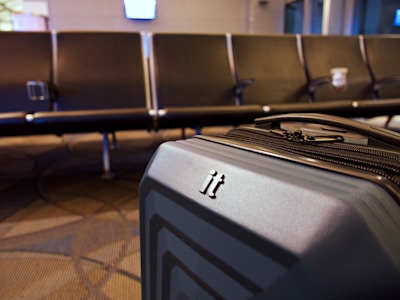 A suitcase left unattended in a hotel lobby with no staff nearby.