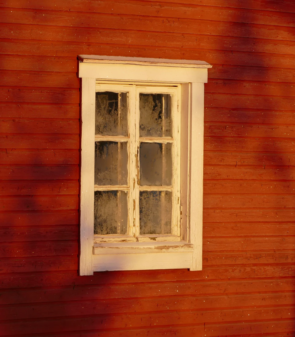 Red wooden house has a slightly open white window casting long shadows indoors