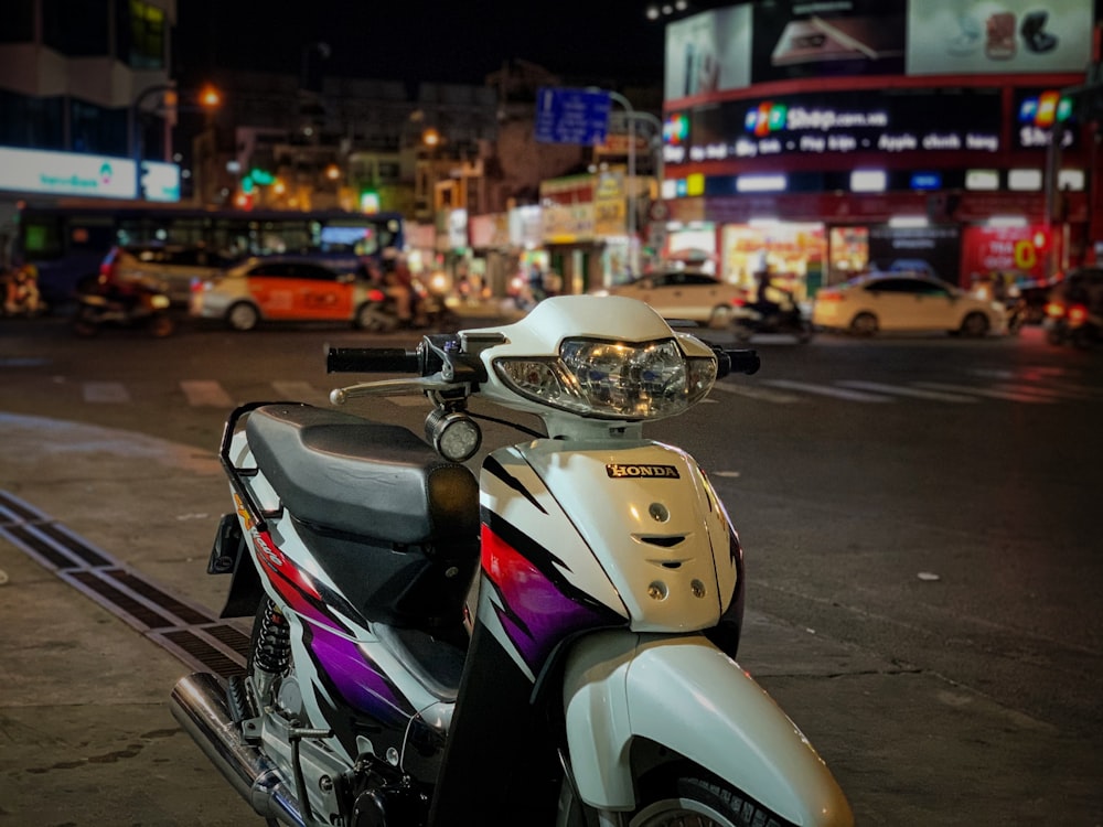 white and black motor scooter