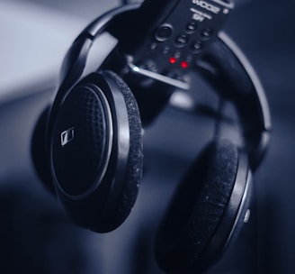 black and gray headphones on black remote control