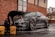 man in black t-shirt and black pants doing water splash on black coupe during daytime