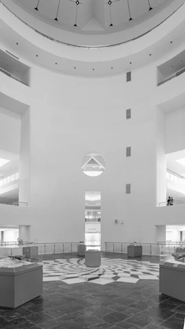 An elegant, minimalist trade fair stand blending form and function seamlessly in a bustling venue.